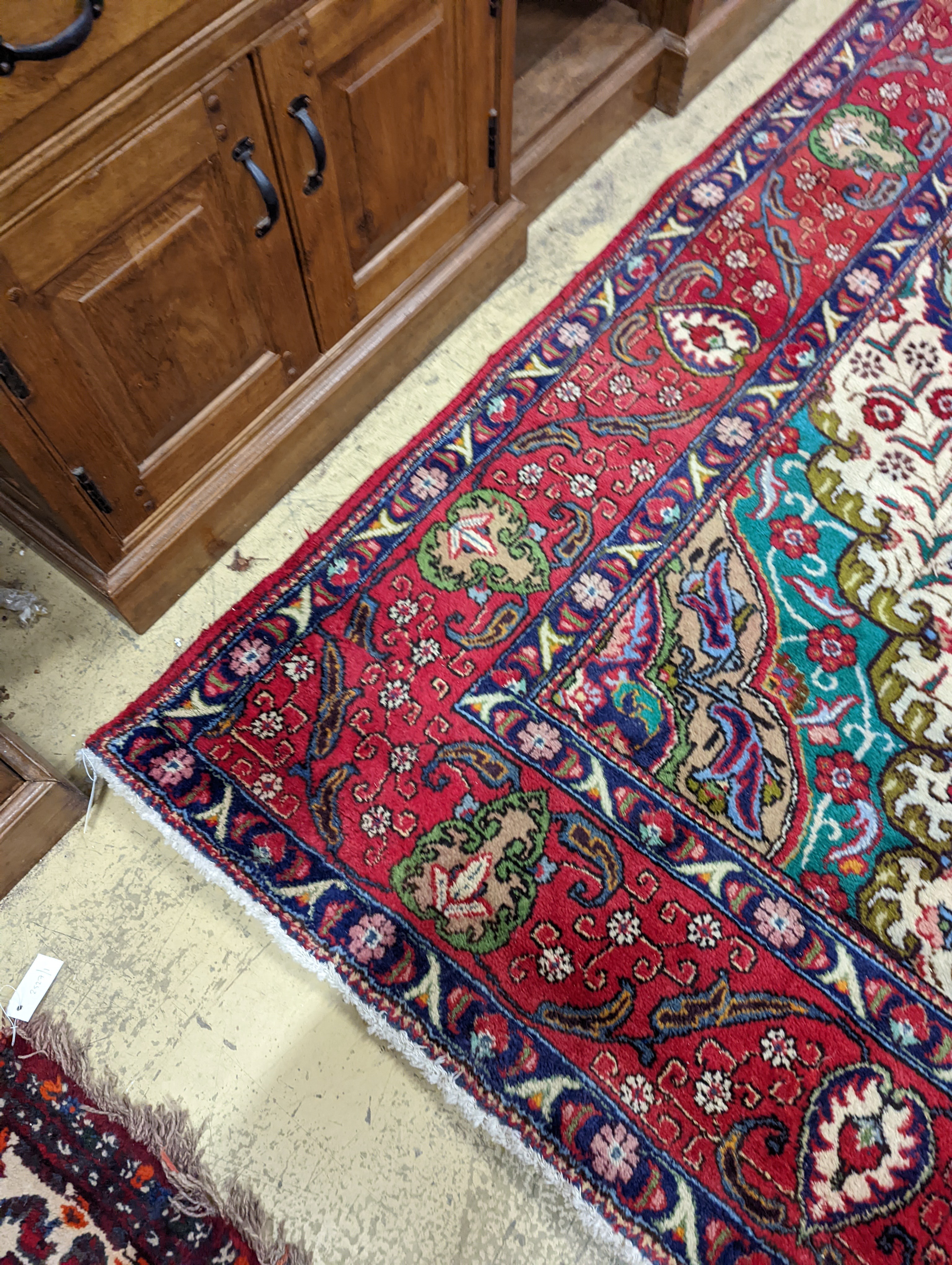 A Tabriz red ground carpet, 380 x 300cm